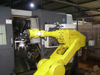 Reconditioned Fanuc S700 robot tending an auto-lathe